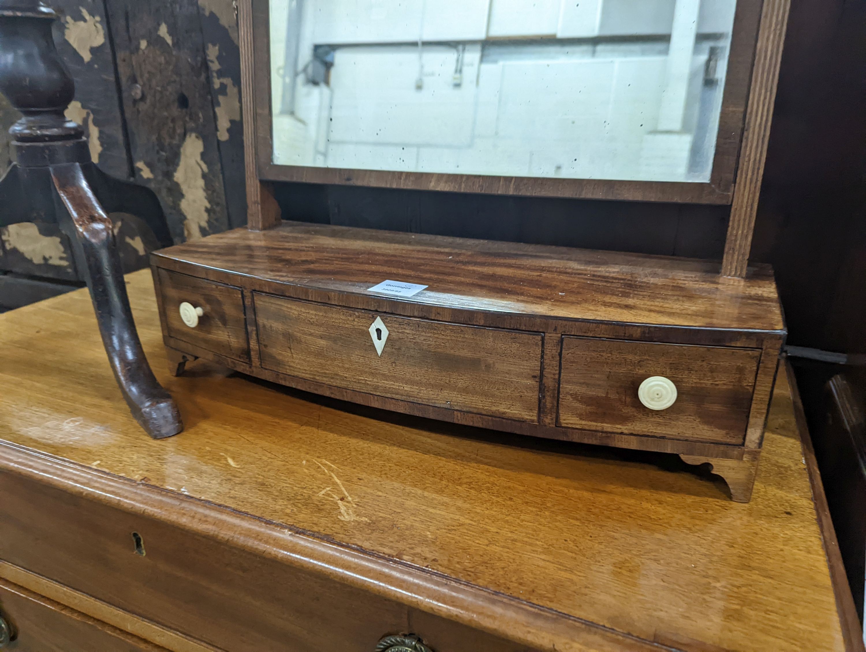 A Regency mahogany bow fronted toilet mirror, width 57cm, height 60cm together with a Regency mahogany tripod wine table